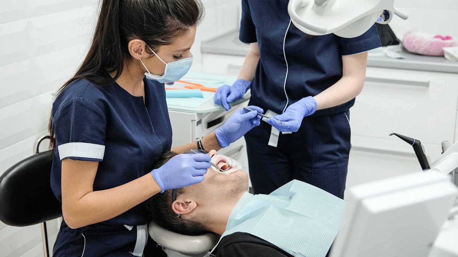 Dental hygienist cleaning a patient's teeth at Marvel Dental in Fort Wayne, IN