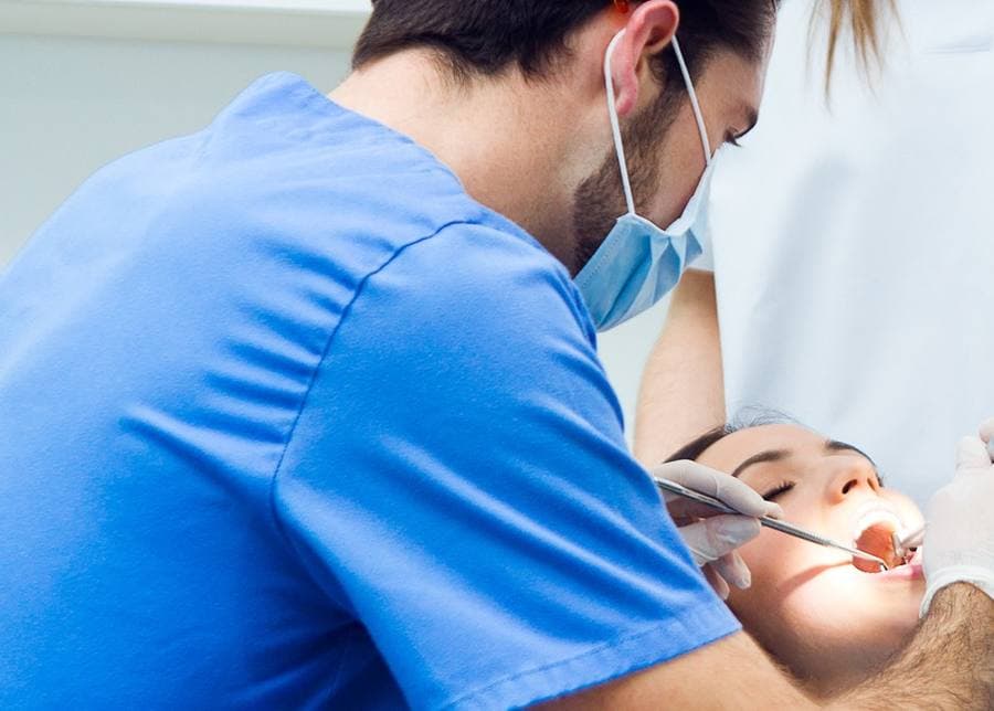 Dentist treating a patient during a dental implant consultation in Fort Wayne